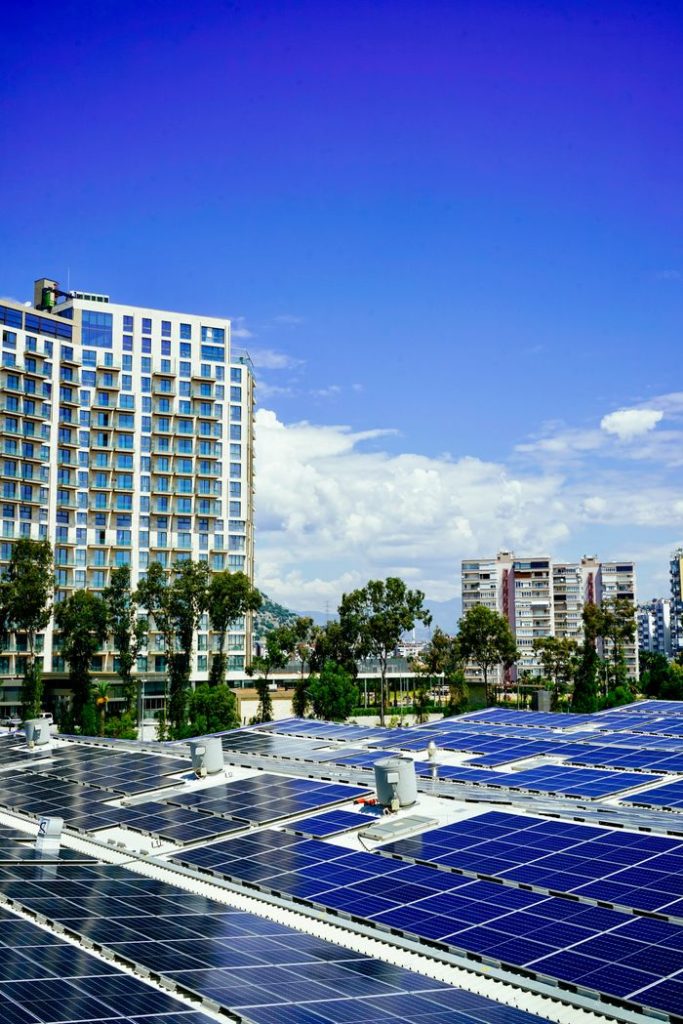Mastering the First Impression: Your intriguing post title goes here High-rise buildings and a large solar panel array under a clear blue sky.