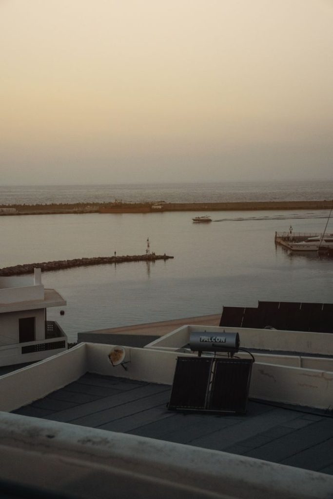 Crafting Captivating Headlines: Your awesome post title goes here Serene coastal scene at sunset featuring a rooftop solar panel and tranquil waters.